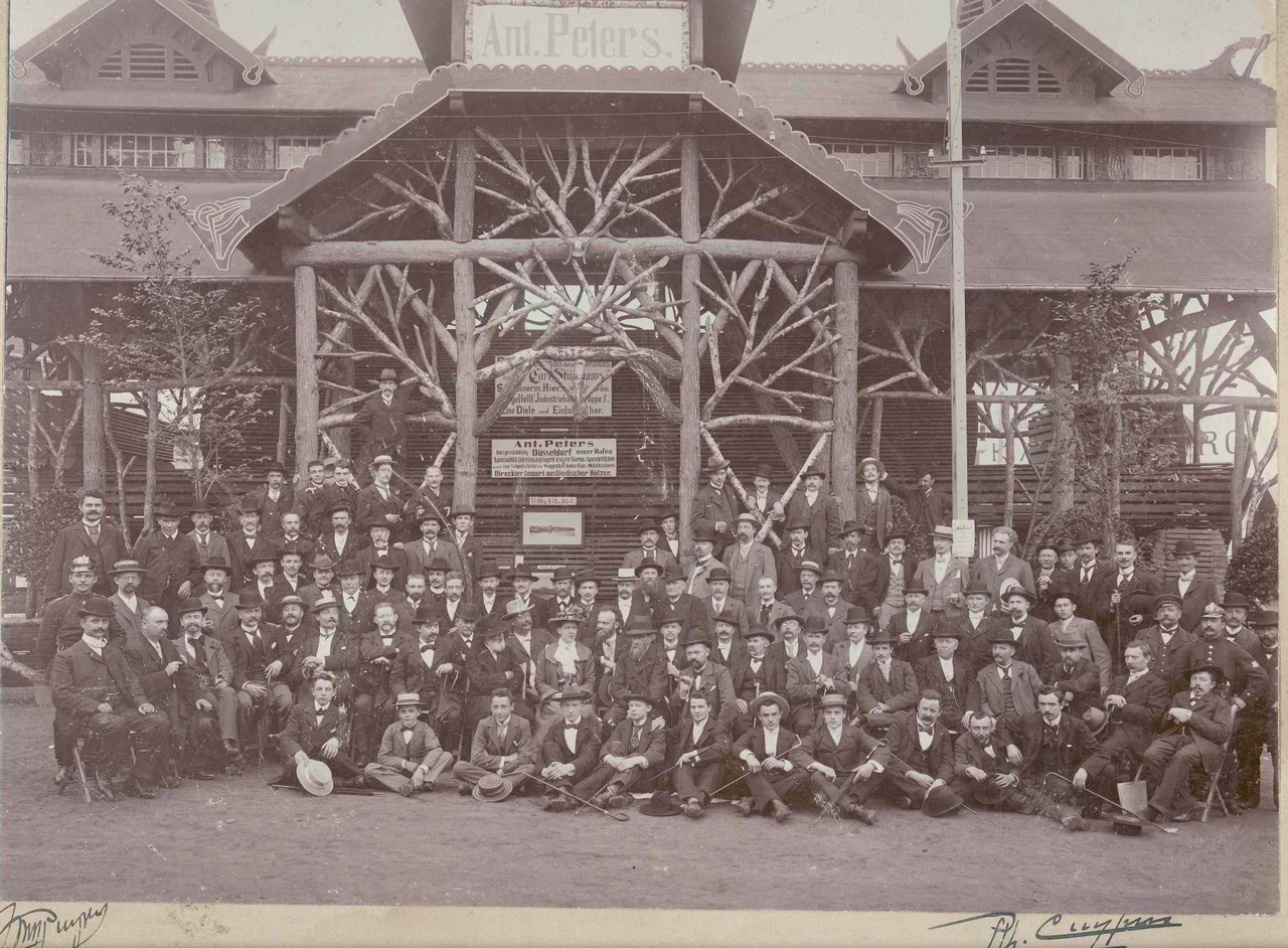 Foto van Dr. P.J.H. Cuypers en Ir. Jos Th Cuypers met het gezamenlijk personeel van de Cuypers Kunstwerkplaatsen