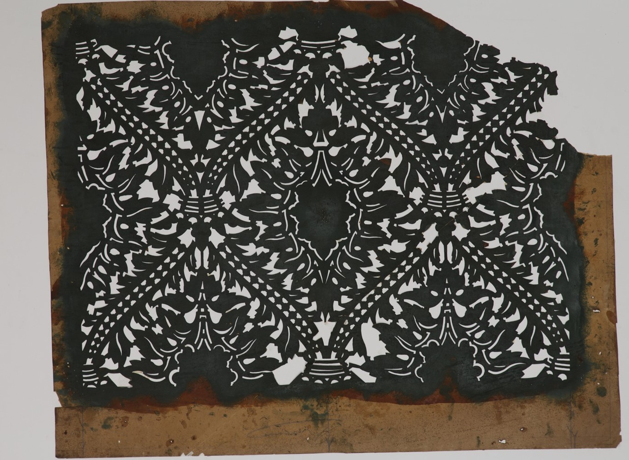 Sjabloon met herhalend patroon met ovaal rozet en blad tussen koordachtige lijnen.